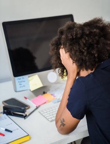stressed woman looking at computer